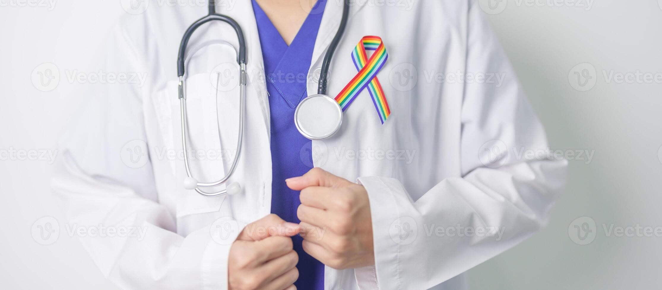 Doctor with LGBTQ Rainbow ribbon for Support Lesbian, Gay, Bisexual, Transgender and Queer community and happy Pride month concept photo