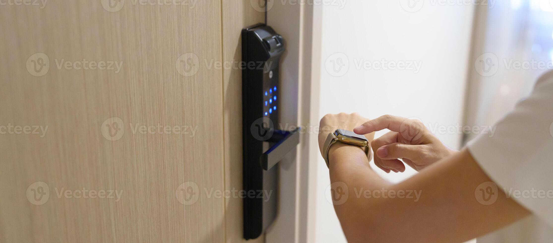 Hand using smartwatch for open digital door lock at home or apartment. NFC Technology, Fingerprint scan, keycard, PIN number, smartphone, electrical and contactless lifestyle concepts photo