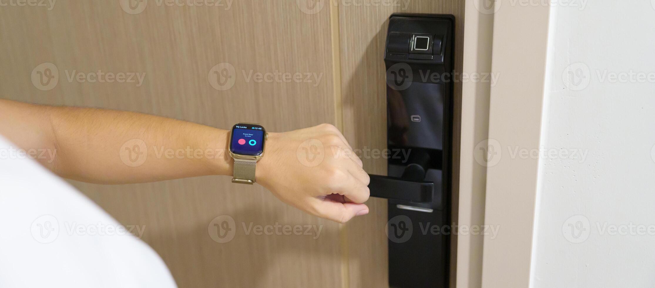 Hand using smartwatch for open digital door lock at home or apartment. NFC Technology, Fingerprint scan, keycard, PIN number, smartphone, electrical and contactless lifestyle concepts photo