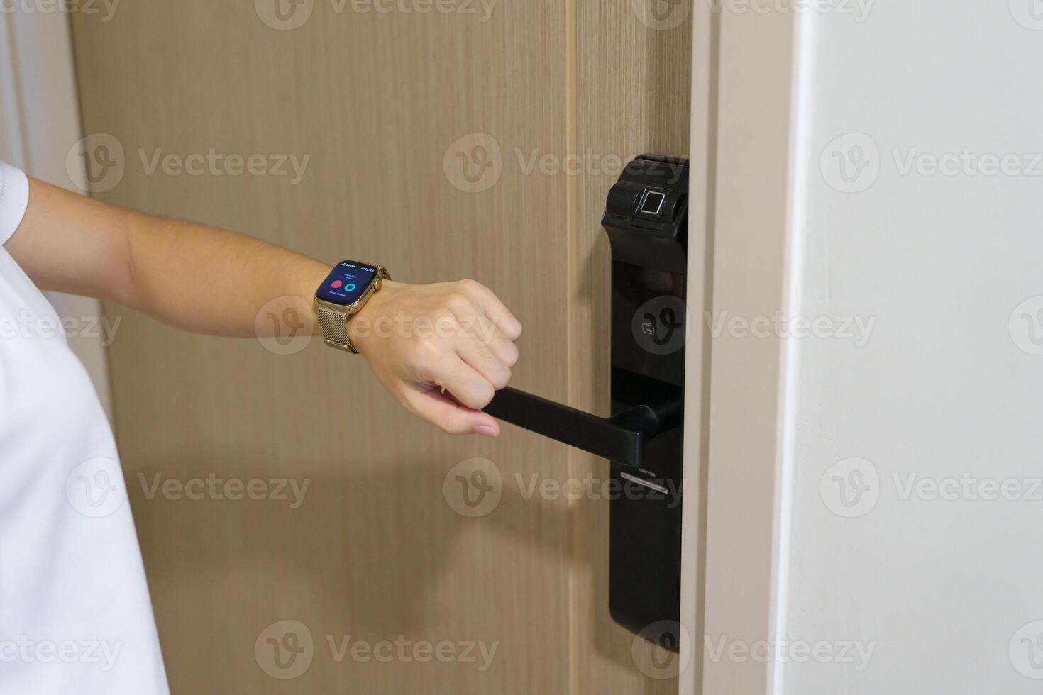 Hand using smartwatch for open digital door lock at home or apartment. NFC Technology, Fingerprint scan, keycard, PIN number, smartphone, electrical and contactless lifestyle concepts photo