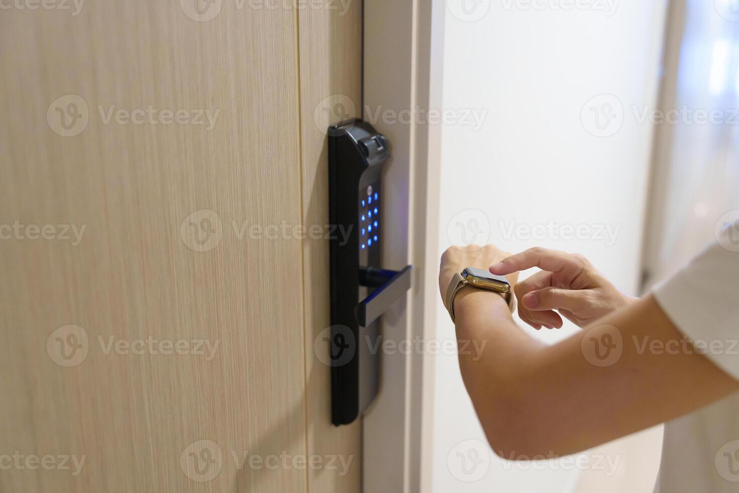 Hand using smartwatch for open digital door lock at home or apartment. NFC Technology, Fingerprint scan, keycard, PIN number, smartphone, electrical and contactless lifestyle concepts photo