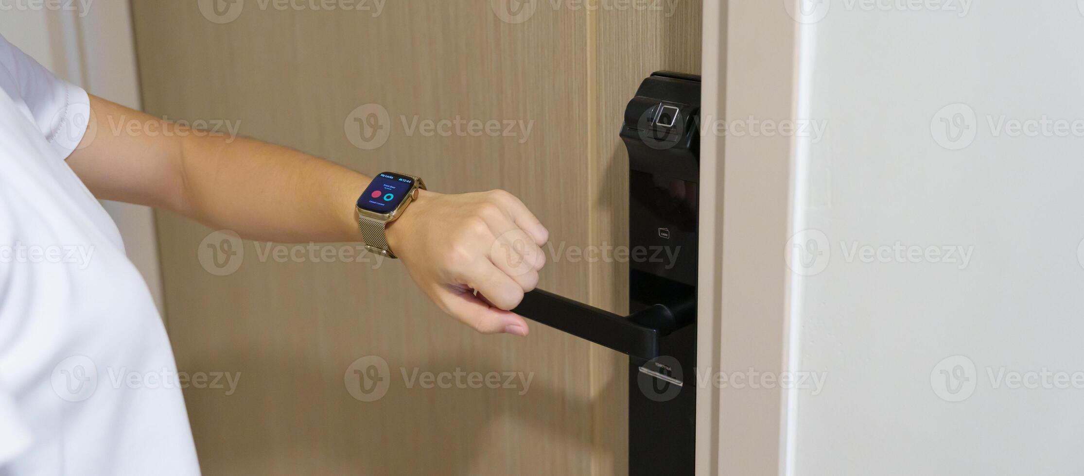 Hand using smartwatch for open digital door lock at home or apartment. NFC Technology, Fingerprint scan, keycard, PIN number, smartphone, electrical and contactless lifestyle concepts photo