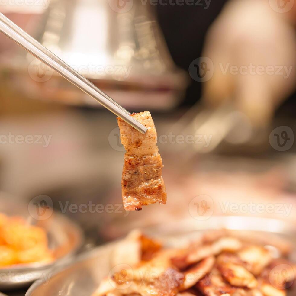 Chef Grilling meat pork on stove serve in restaurant. Korean food and BBQ traditional style photo