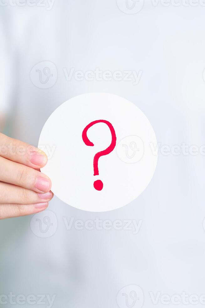Woman show Questions Mark on paper. FAQ, frequency asked questions, Answer, Q and A, Information, Communication and interrogation Concepts photo