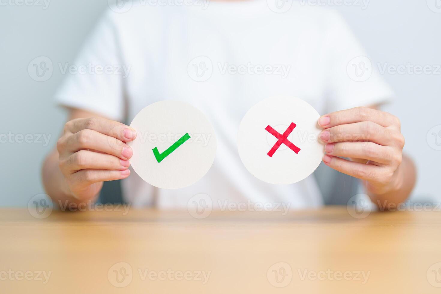 Woman show Wrong and Right symbol paper. True and false, accept and rejected, evaluation, Vote, Poll, Yes or No and Survey concepts photo