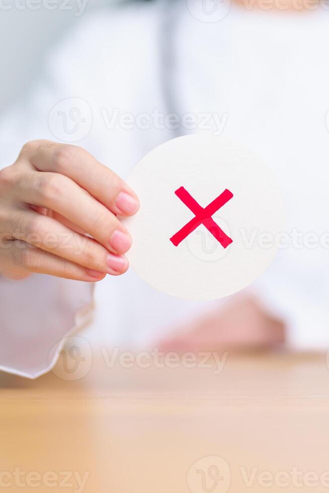Doctor show Wrong symbol paper. True and false, accept and rejected, evaluation, Diagnosis, Vote, Poll, Yes or No, Health, Medical and Survey concepts photo