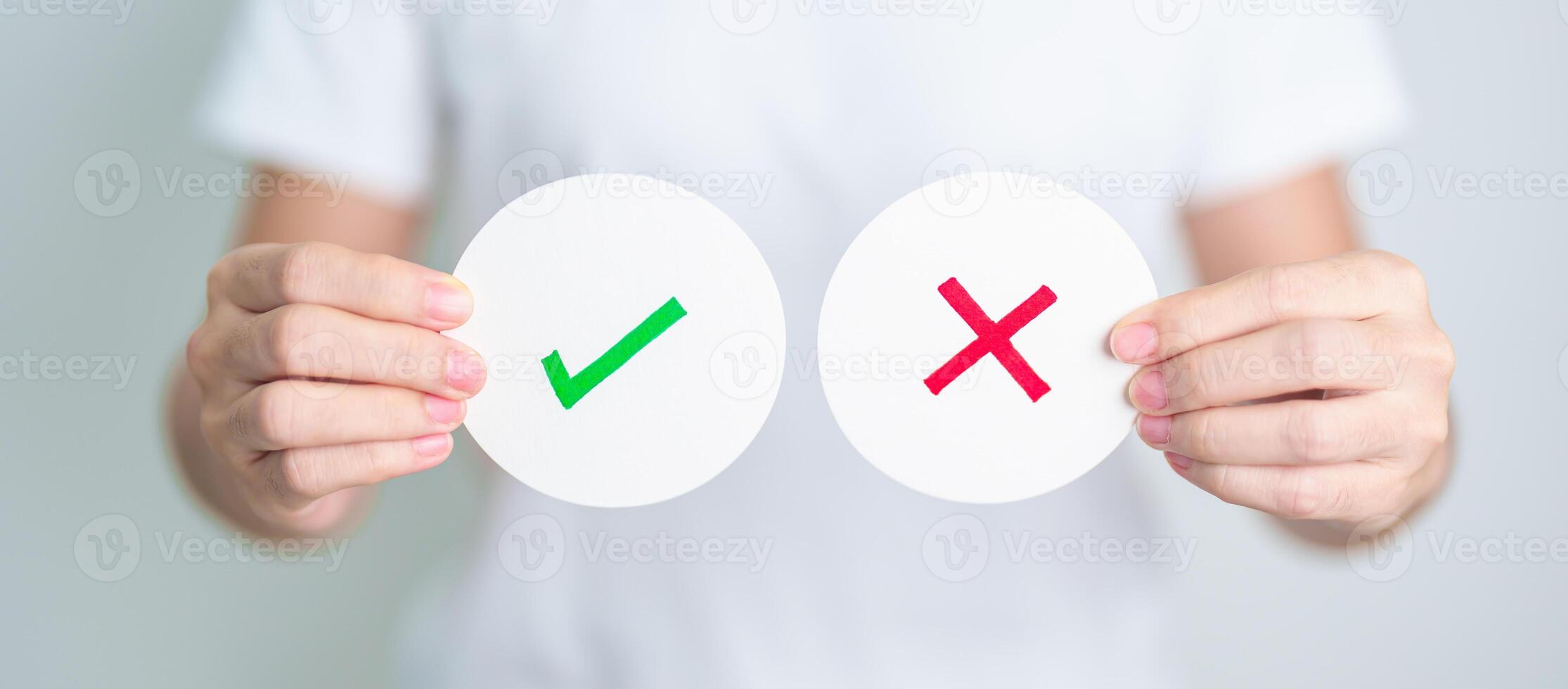 Woman show Wrong and Right symbol paper. True and false, accept and rejected, evaluation, Vote, Poll, Yes or No and Survey concepts photo