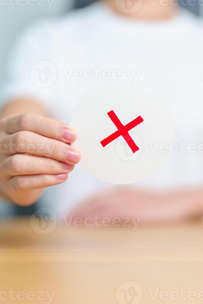 Woman show Wrong symbol paper. True and false, accept and rejected, evaluation, Vote, Poll, Yes or No and Survey concepts photo