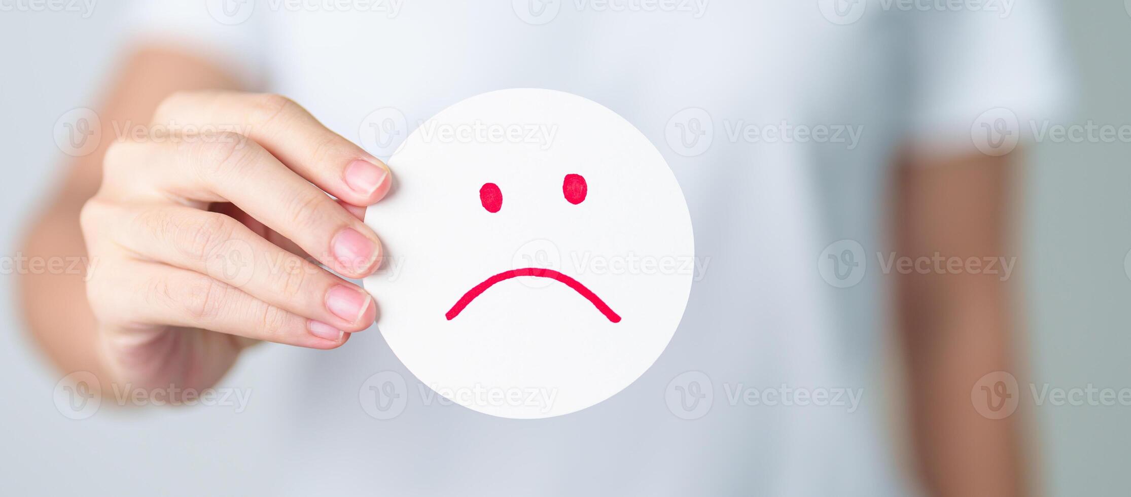 Woman show Unhappy Sad face paper, Mental health Assessment, Psychology, Health Wellness, Feedback, Customer Review, Experience, Satisfaction Survey, Negative Thinking and World Mental Health day photo