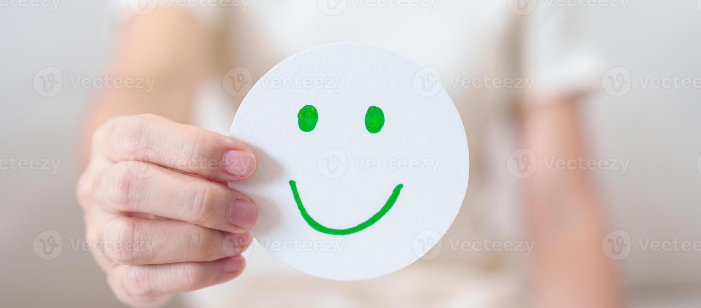 Woman show Happy Smile face paper, Mental health Assessment, Psychology, Health Wellness, Feedback, Customer Review, Experience, Satisfaction Survey, Positive Thinking and World Mental Health day photo