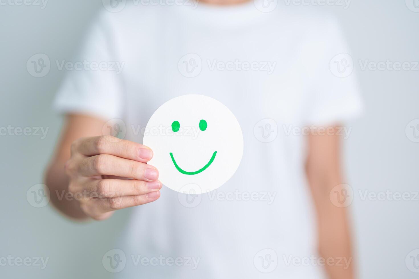 Woman show Happy Smile face paper, Mental health Assessment, Psychology, Health Wellness, Feedback, Customer Review, Experience, Satisfaction Survey, Positive Thinking and World Mental Health day photo