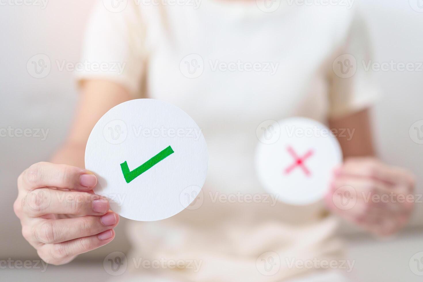 Woman show Right symbol paper. True and false, accept and rejected, evaluation, Vote, Poll, Yes or No and Survey concepts photo