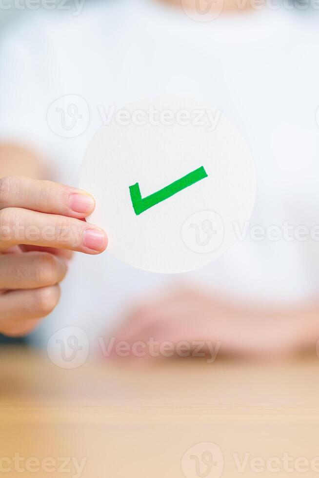 Woman show Right symbol paper. True and false, accept and rejected, evaluation, Vote, Poll, Yes or No and Survey concepts photo