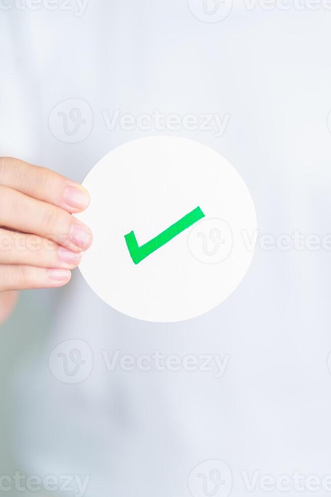 Woman show Right symbol paper. True and false, accept and rejected, evaluation, Vote, Poll, Yes or No and Survey concepts photo
