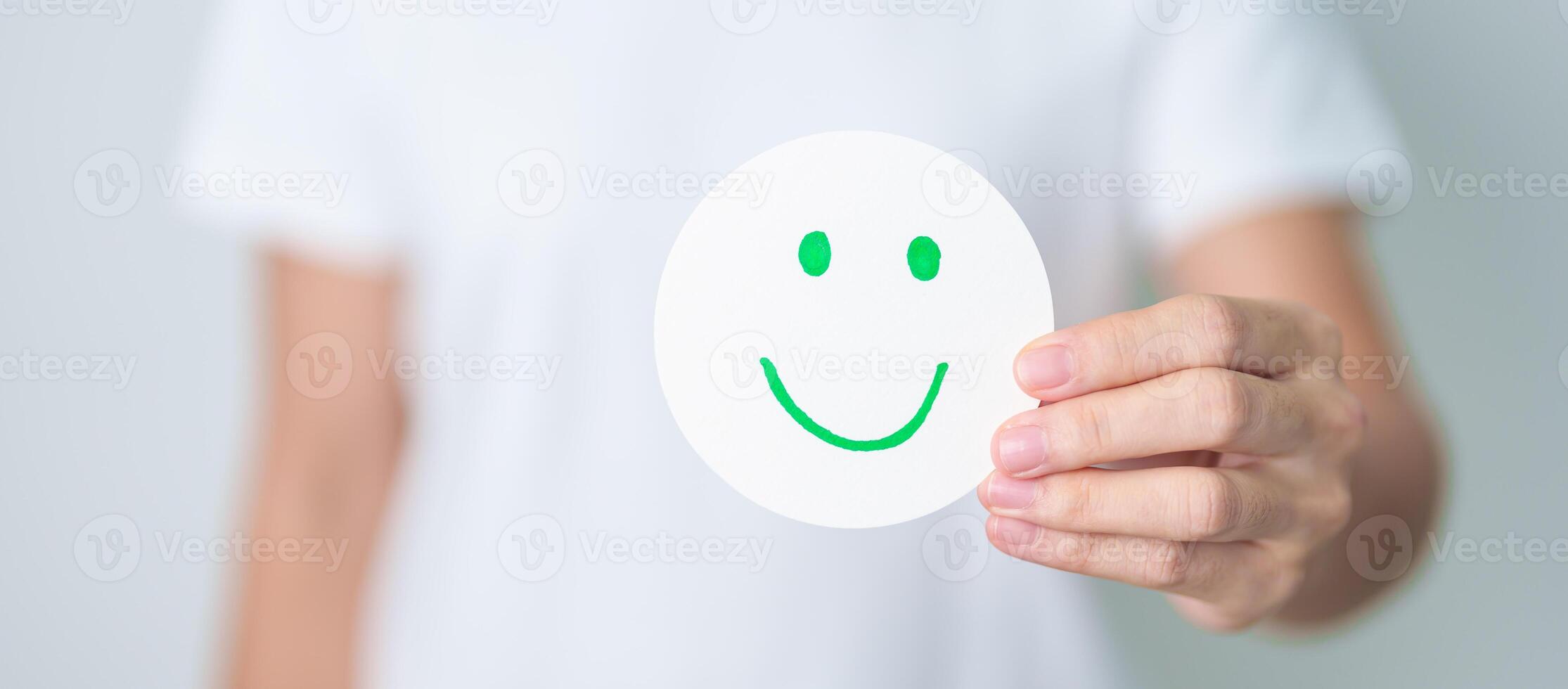 Woman show Happy Smile face paper, Mental health Assessment, Psychology, Health Wellness, Feedback, Customer Review, Experience, Satisfaction Survey, Positive Thinking and World Mental Health day photo