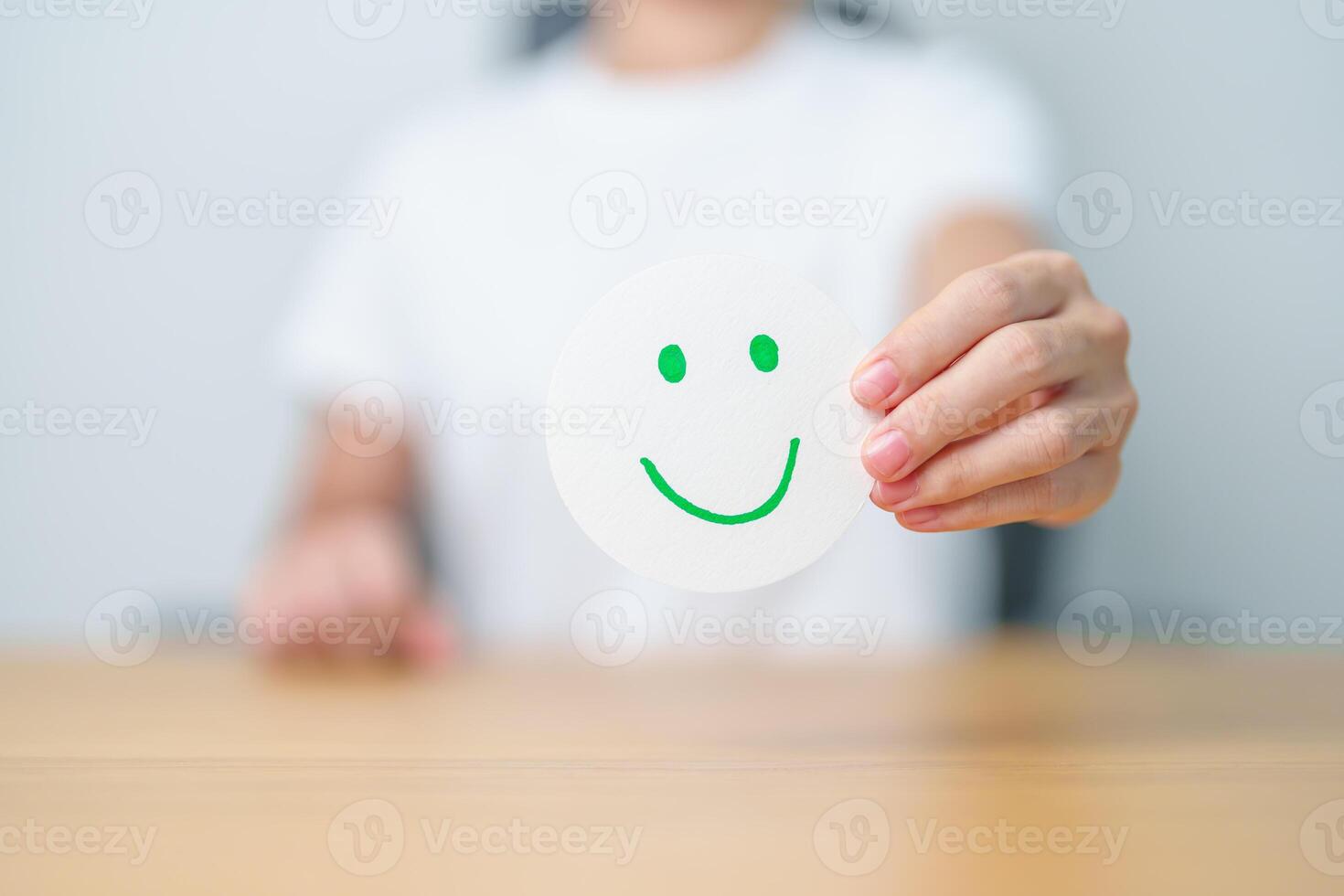 Woman show Happy Smile face paper, Mental health Assessment, Psychology, Health Wellness, Feedback, Customer Review, Experience, Satisfaction Survey, Positive Thinking and World Mental Health day photo