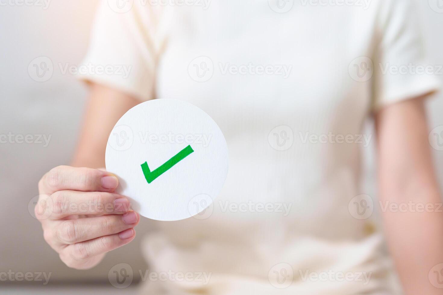 Woman show Right symbol paper. True and false, accept and rejected, evaluation, Vote, Poll, Yes or No and Survey concepts photo