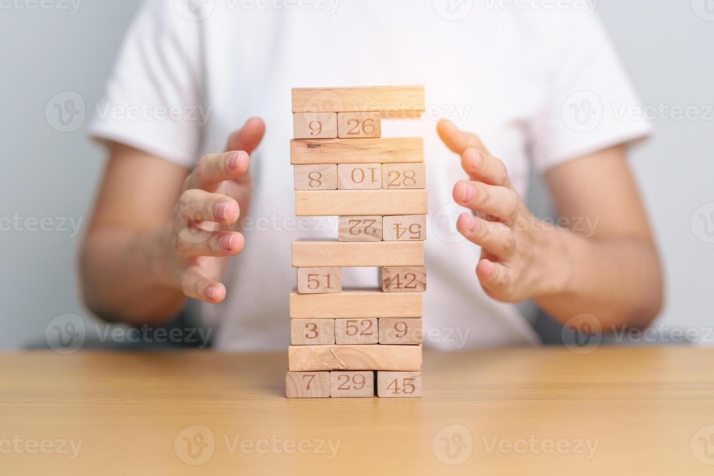 hand cover wooden block on the tower. Business planning, Risk Management, Solution, insurance and strategy Concepts photo