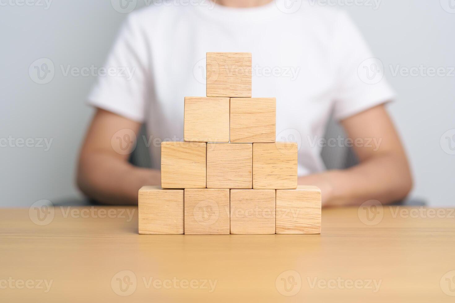 hand placing or pulling wooden block on the building. Business planning, Risk Management, Solution and strategy Concepts photo
