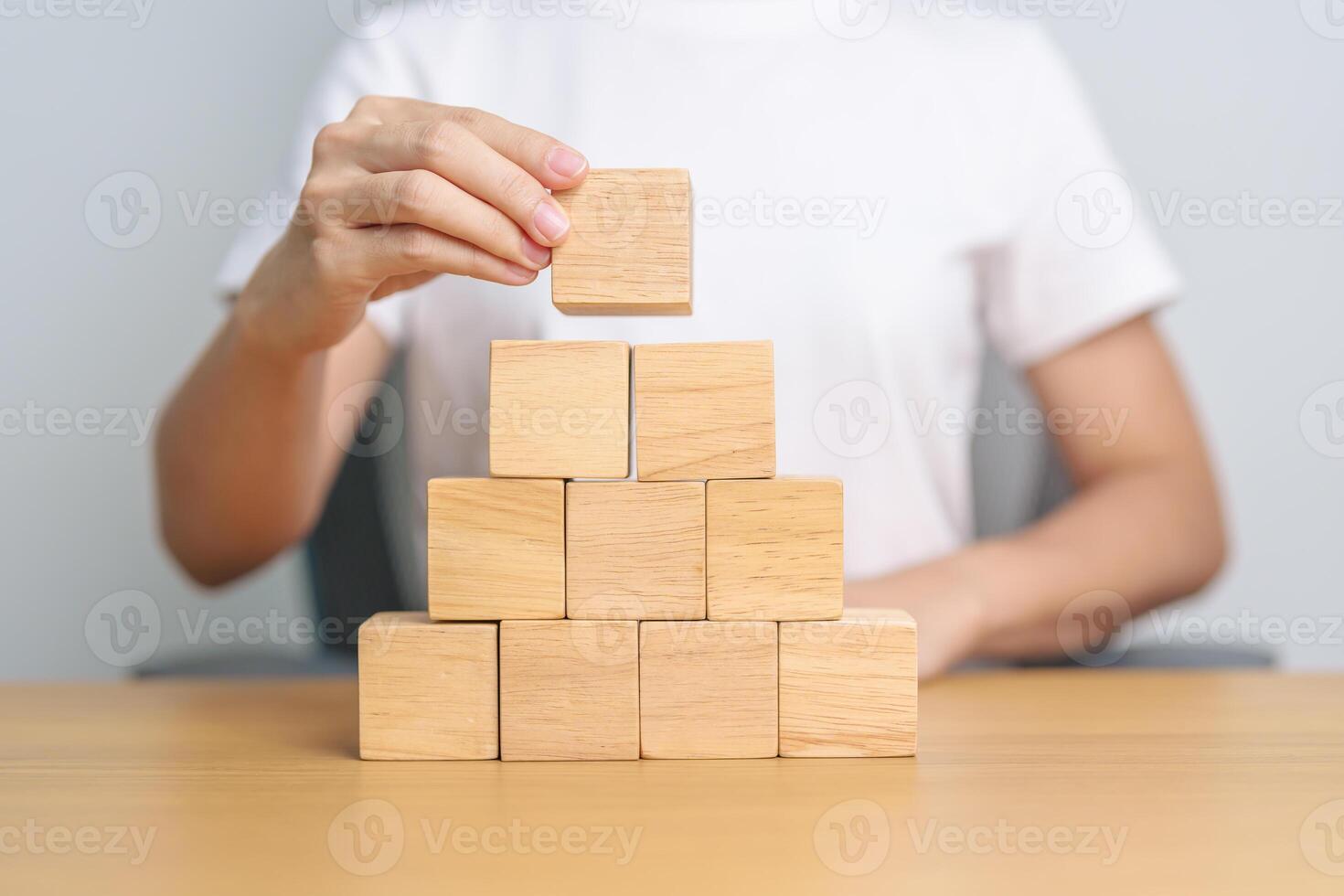 hand placing or pulling wooden block on the building. Business planning, Risk Management, Solution and strategy Concepts photo