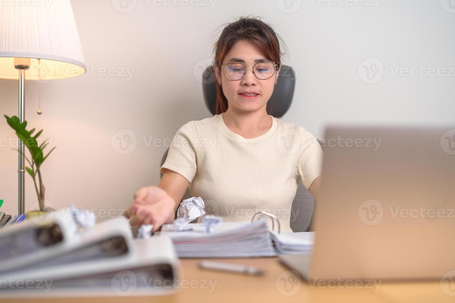 stressed Asian Woman using laptop with mistake paper, Tired female businesswoman working overload at office, Exhausted casual woman with computer at late night in home. Failure, Problem and business photo