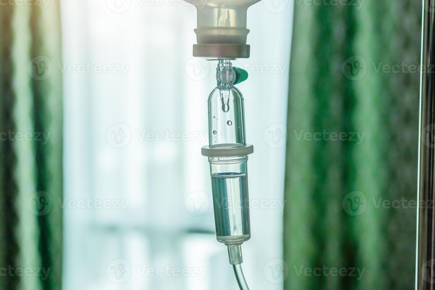 Close up medical intravenous IV drip in hospital background photo