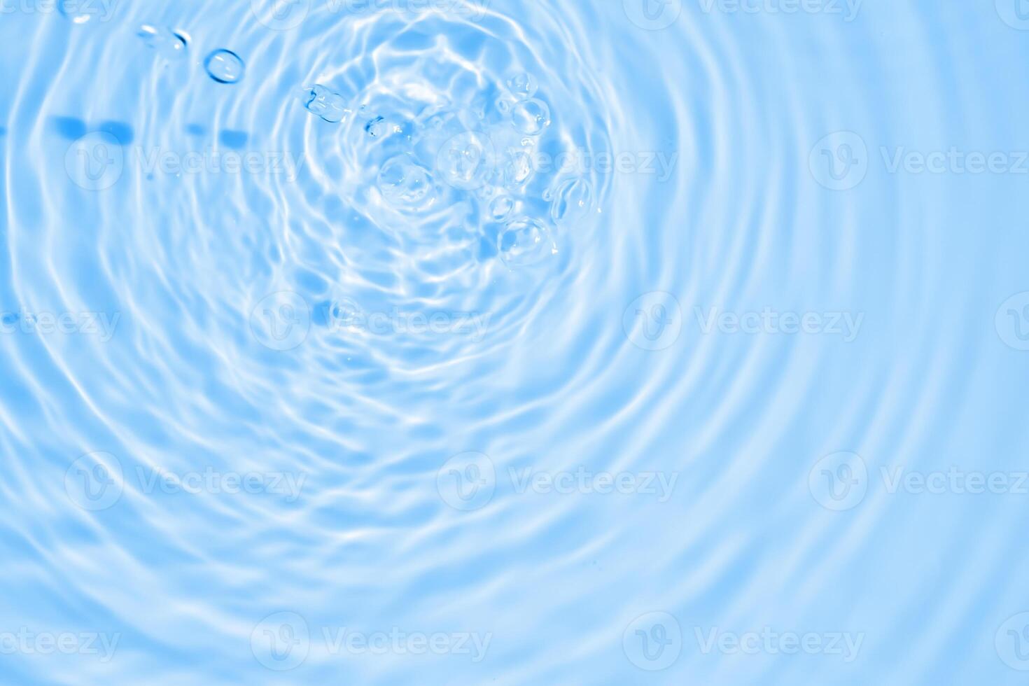 Abstract transparent water shadow surface texture natural ripple on blue background photo