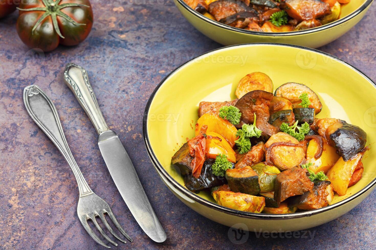 Delicious vegetable stew in a bowl on the table. photo