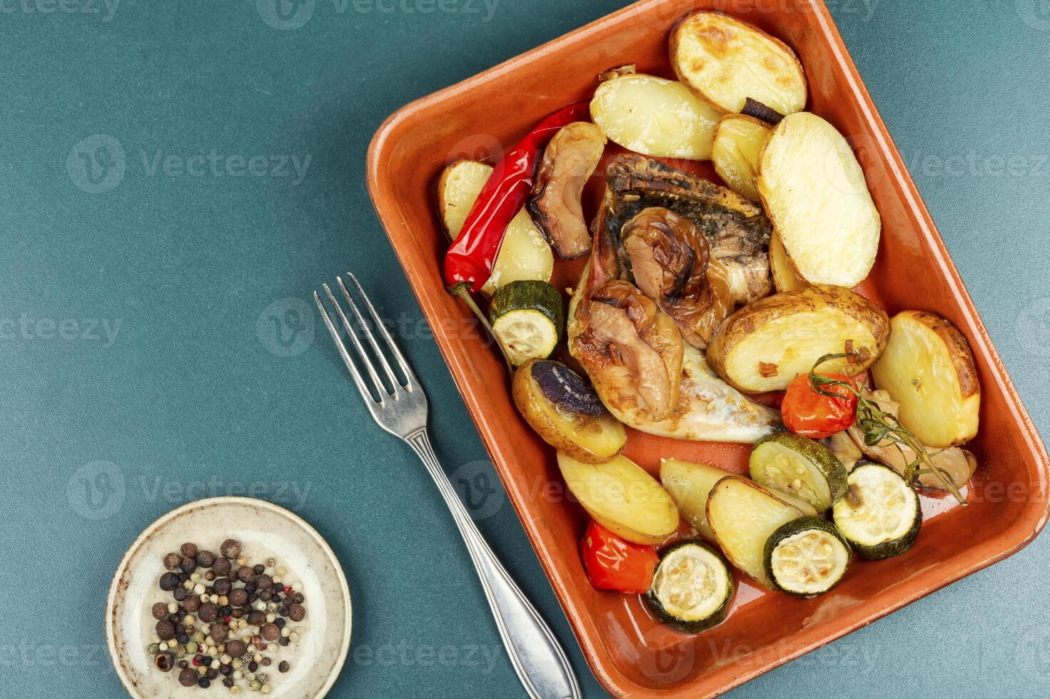Chicken legs baked with potatoes. photo