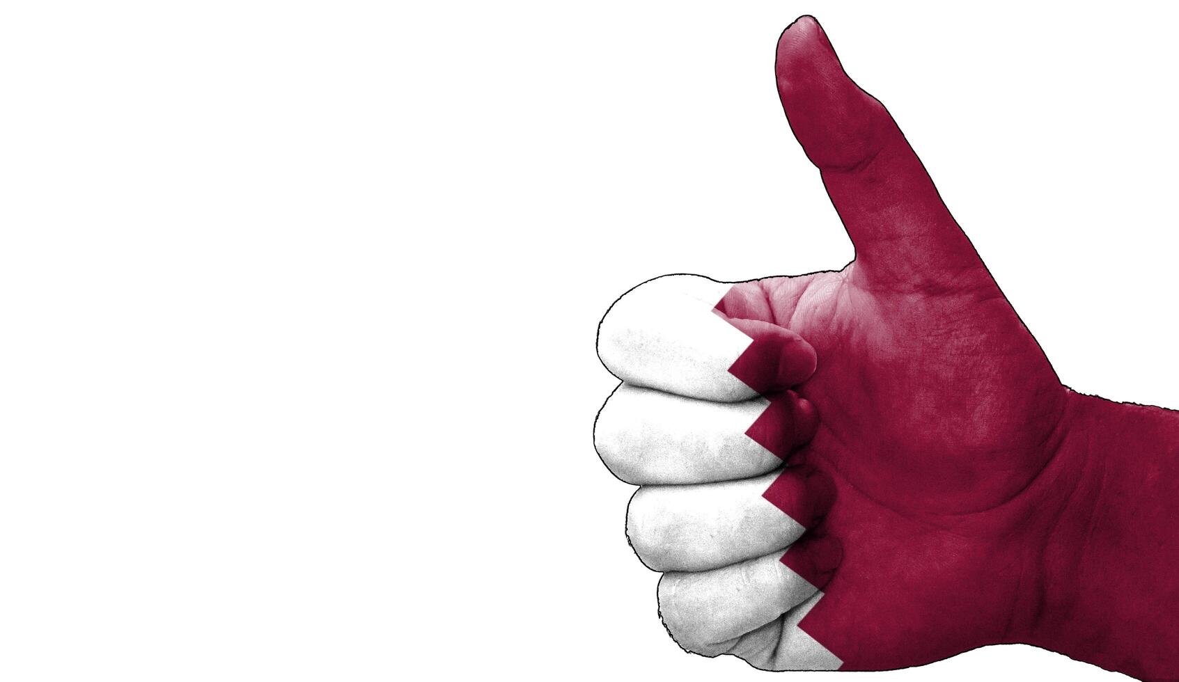 thumbs up in approval with the Qatari flag painted photo