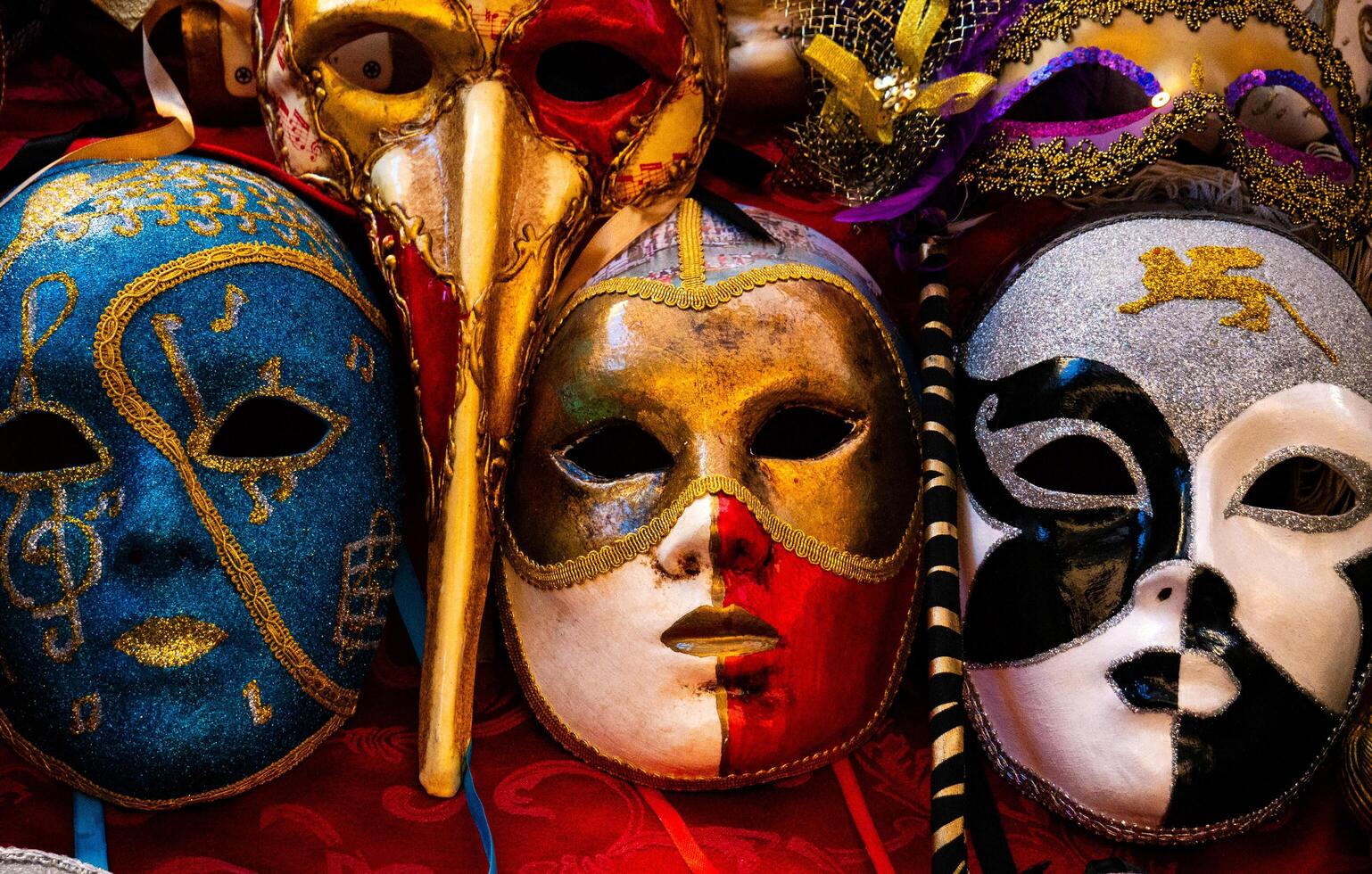 shop in italy close up three typical venetian masks with intricate decorations and details photo
