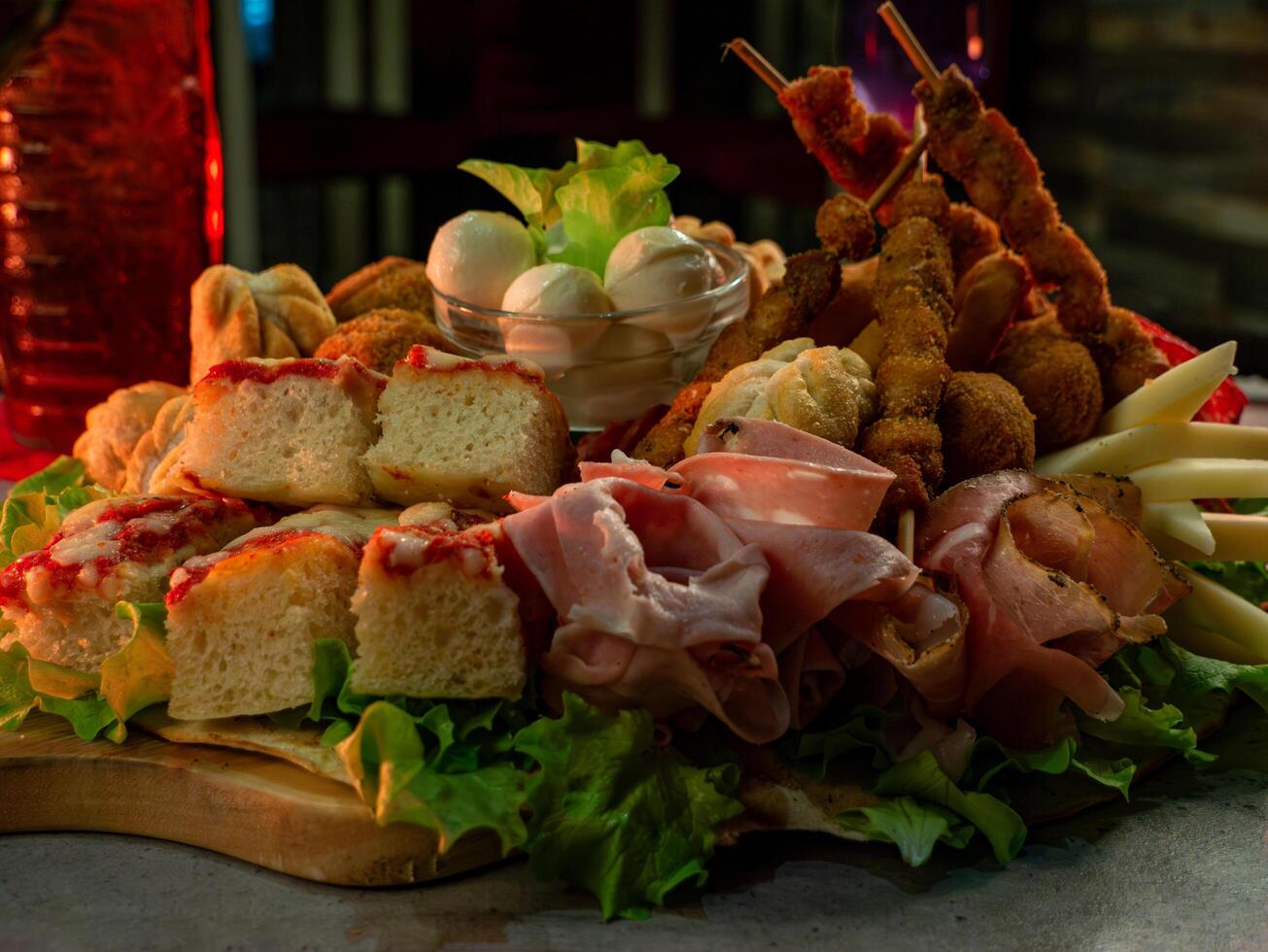 close up shot of a plate of salty snacks on a tray for an Italian aperitif or appetizers for a party photo