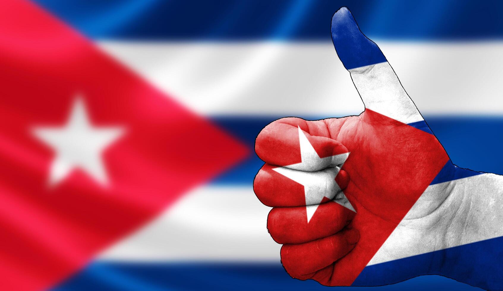 thumbs up in approval with the Cuban flag painted, photo
