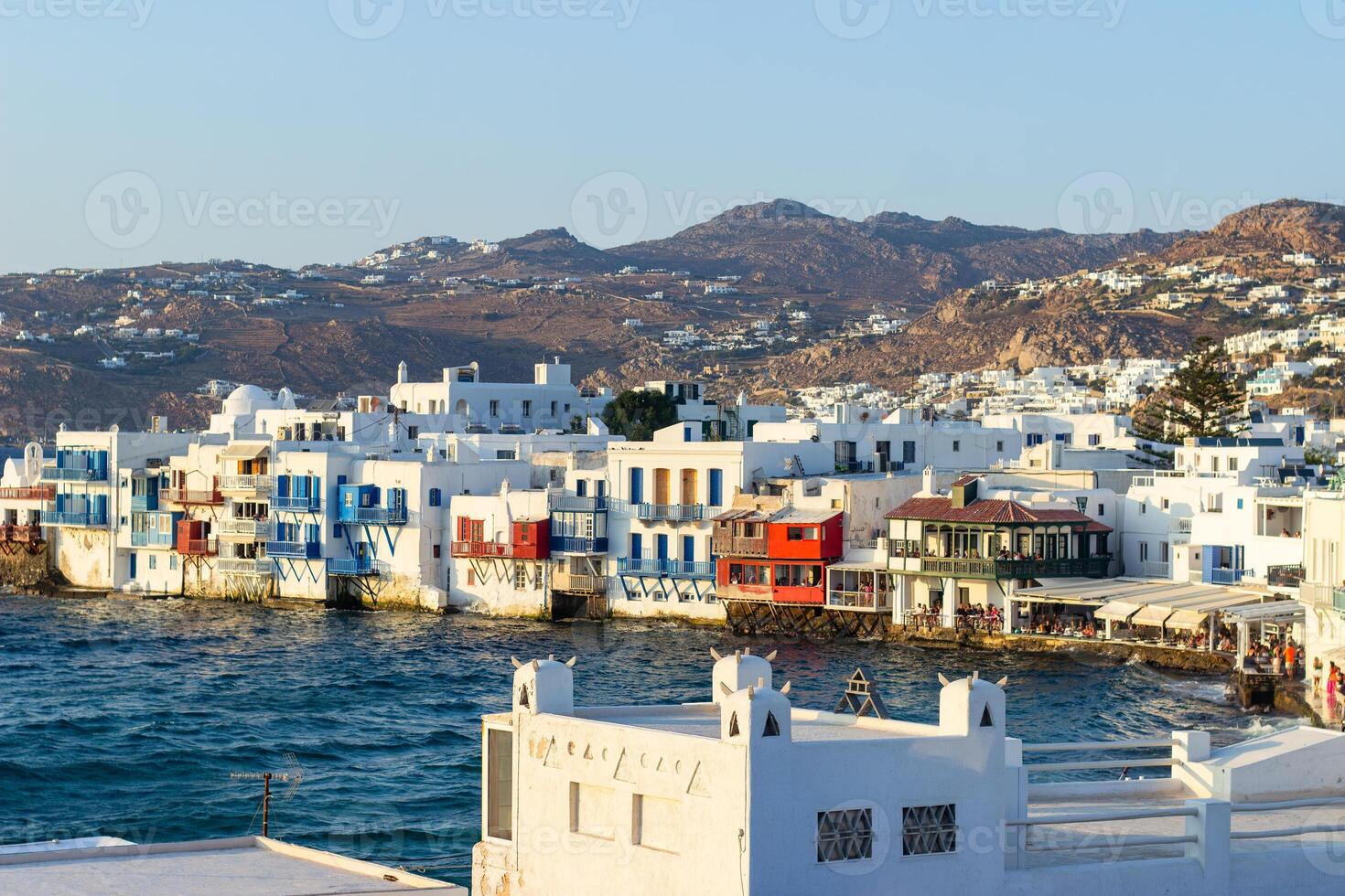 View of traditional greek village with white houses on Mykonos Island, Greece photo