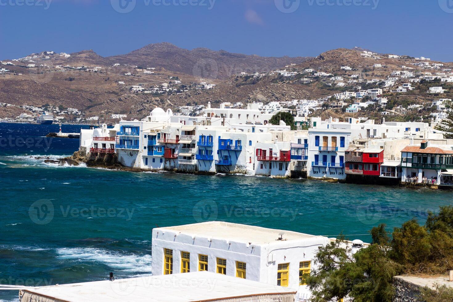 View of traditional greek village with white houses on Mykonos Island, Greece photo