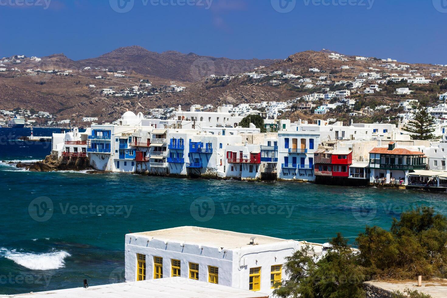 View of traditional greek village with white houses on Mykonos Island, Greece photo