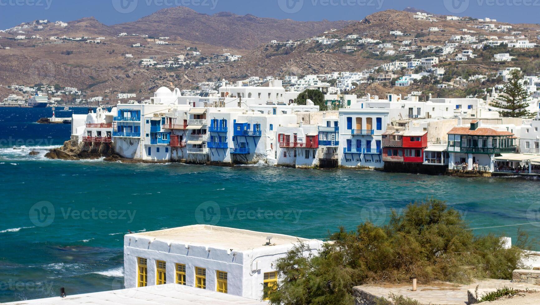 View of traditional greek village with white houses on Mykonos Island, Greece photo