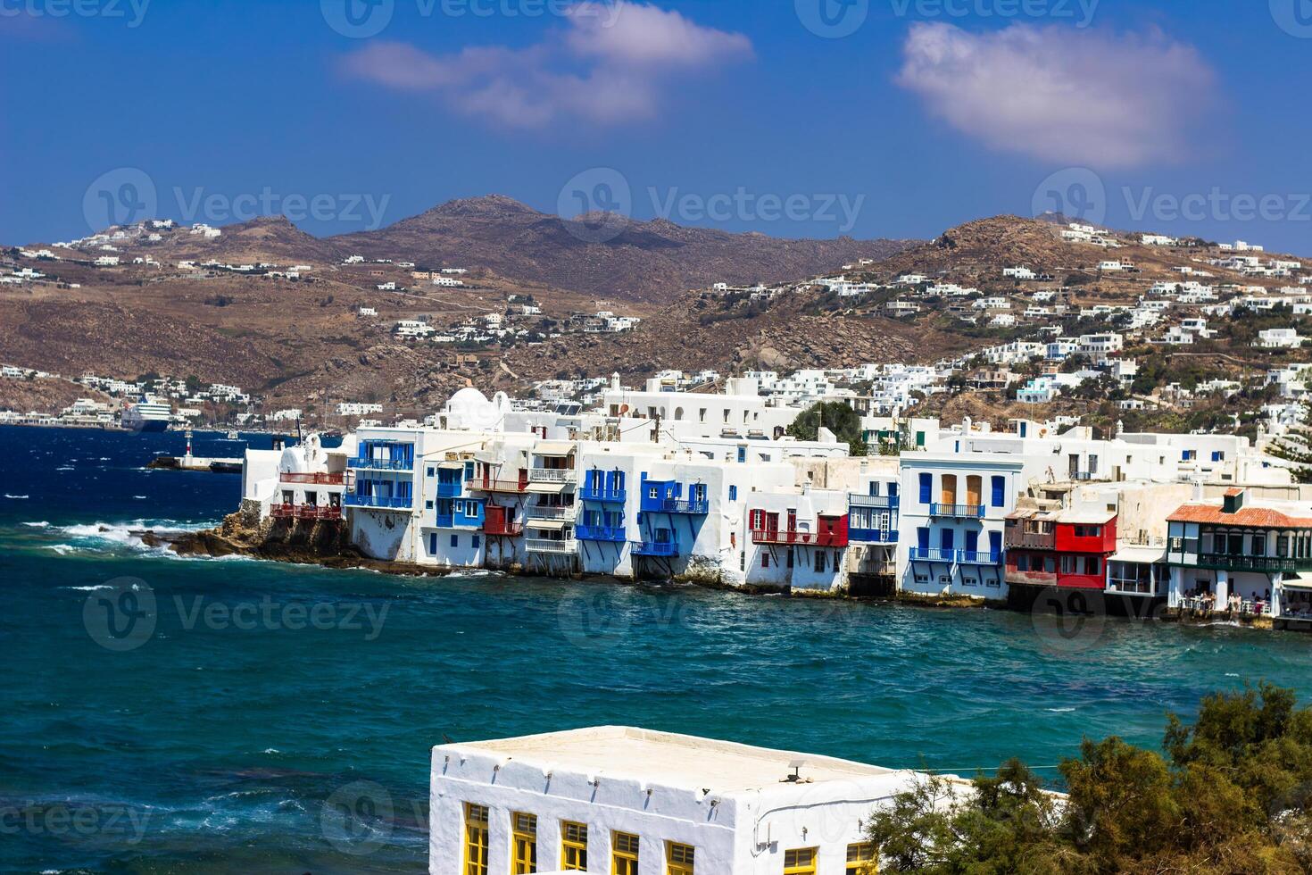 View of traditional greek village with white houses on Mykonos Island, Greece photo