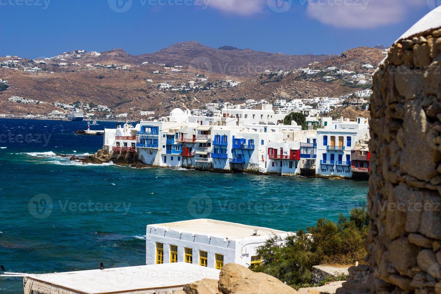 View of traditional greek village with white houses on Mykonos Island, Greece photo