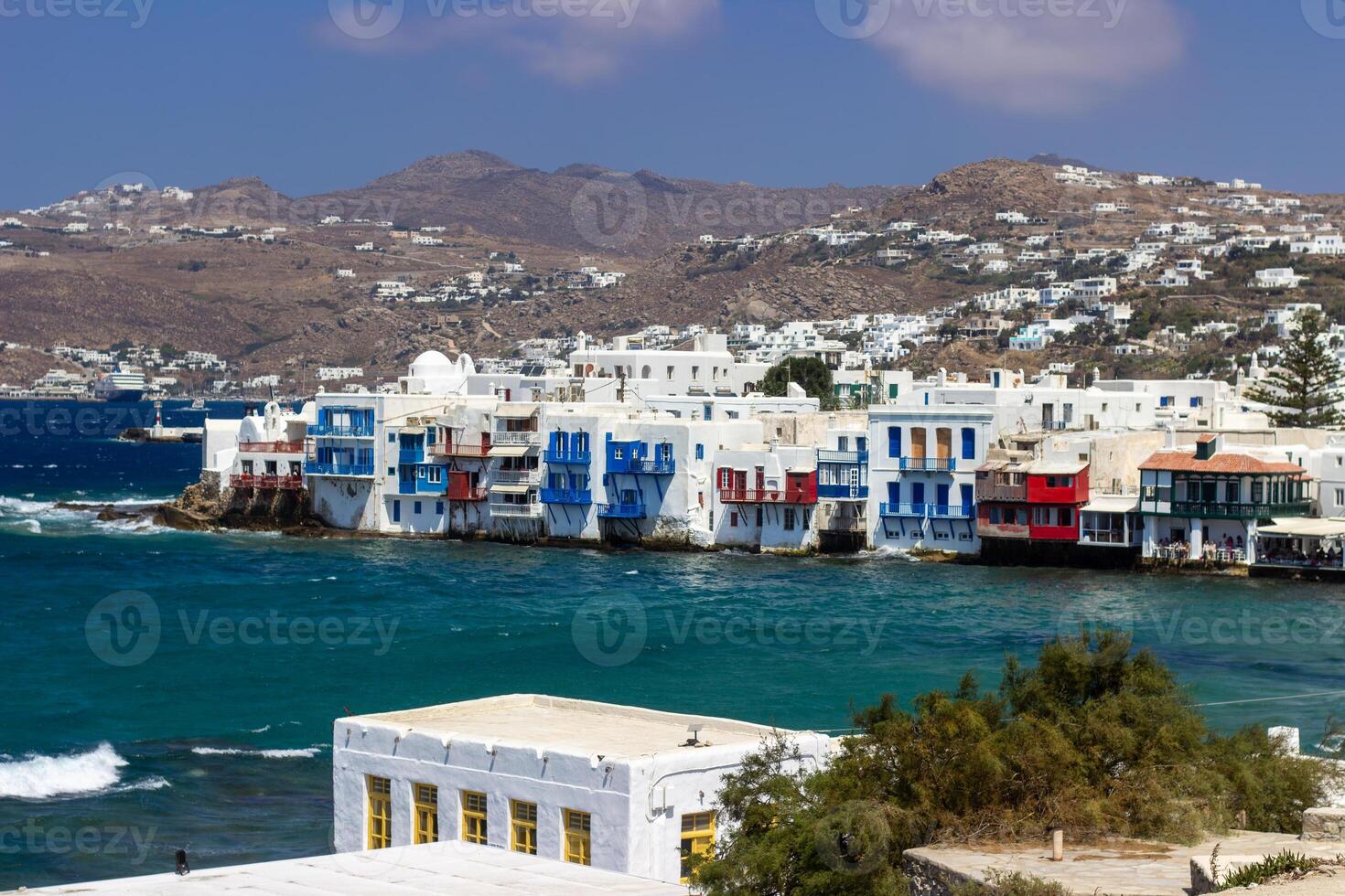 View of traditional greek village with white houses on Mykonos Island, Greece photo