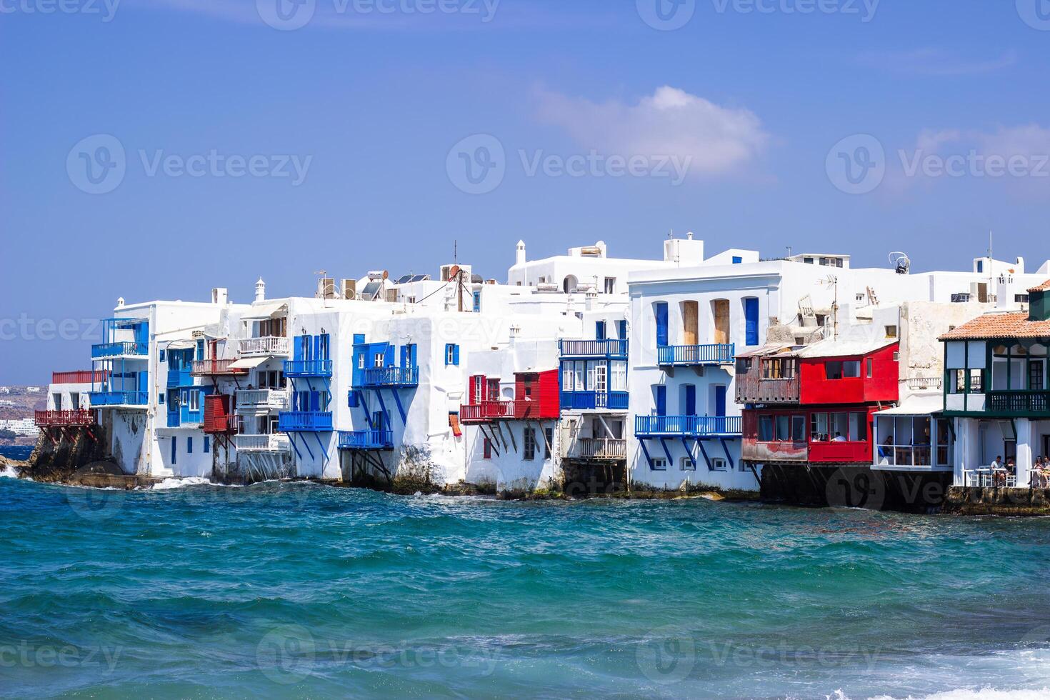 View of traditional greek village with white houses on Mykonos Island, Greece photo