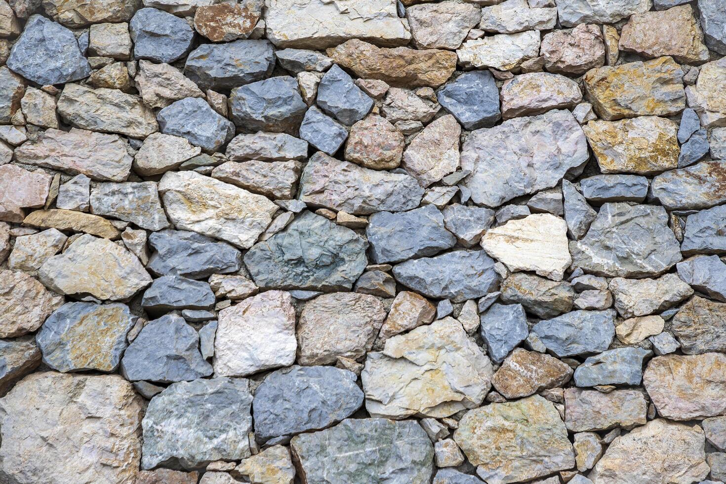 The surface of an old stone wall, perfect for the background. photo