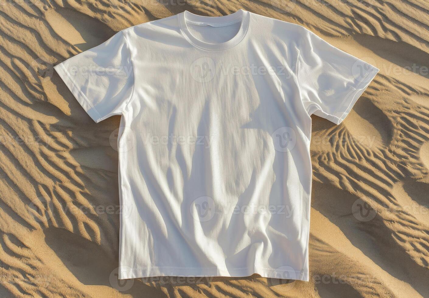 White t-shirt on sand texture. Casual blank shirt textile. Empty mock up cloth collection. Cotton tshirt in nature coastline background. Mockup blank fashion desert design photo