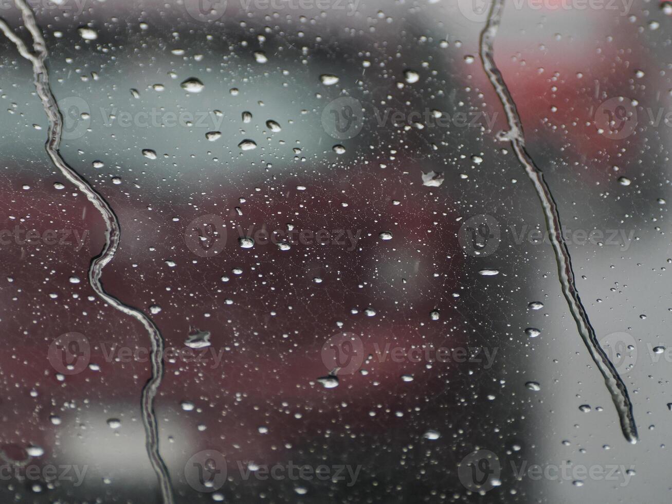 heavy rain slow motion on car window while driving photo