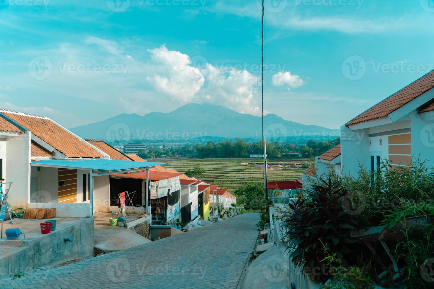 Residential area with beautiful views with a backdrop of green rice fields and mountains that look magnificent from a distance. Public housing complex on hills with sloping land with mountain views photo