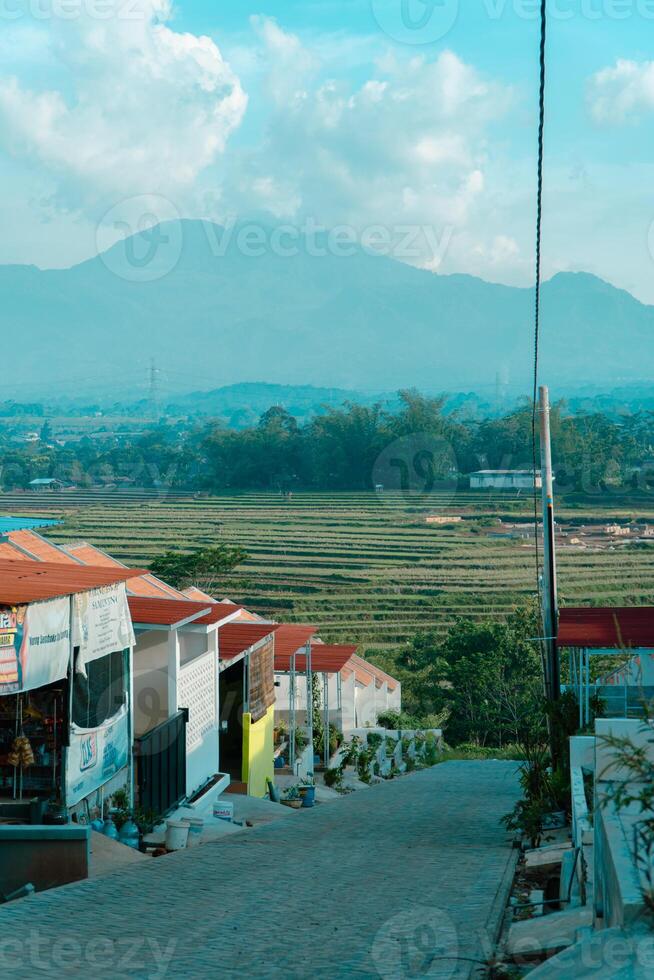 Residential area with beautiful views with a backdrop of green rice fields and mountains that look magnificent from a distance. Public housing complex on hills with sloping land with mountain views photo