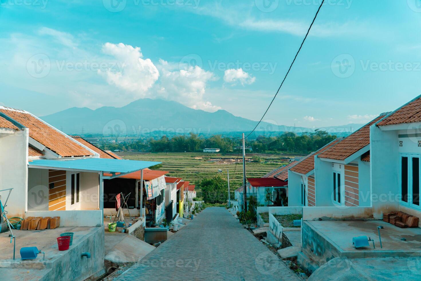 Residential area with beautiful views with a backdrop of green rice fields and mountains that look magnificent from a distance. Public housing complex on hills with sloping land with mountain views photo