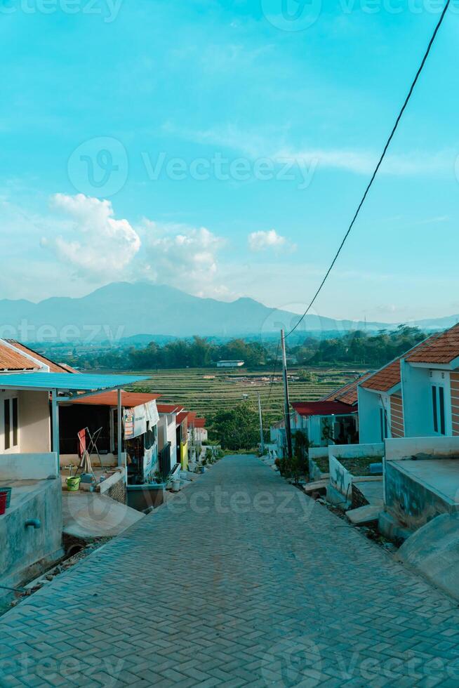 Residential area with beautiful views with a backdrop of green rice fields and mountains that look magnificent from a distance. Public housing complex on hills with sloping land with mountain views photo