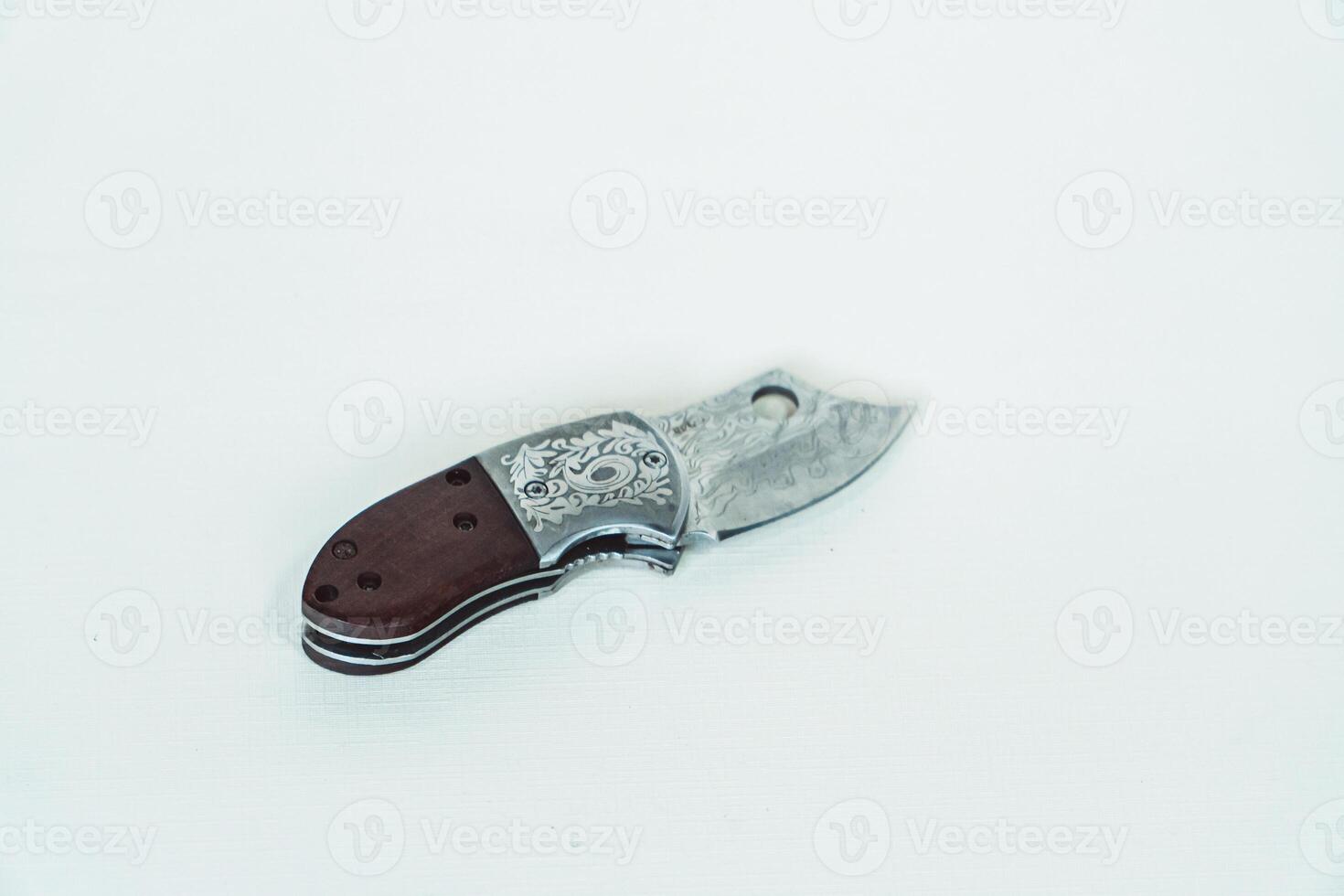 Close up of an adventure and bushcraft knife using a wooden handle. Knife with a sharp stainless steel blade with a wooden handle, perfect for outdoor adventures and bushcraft activities photo