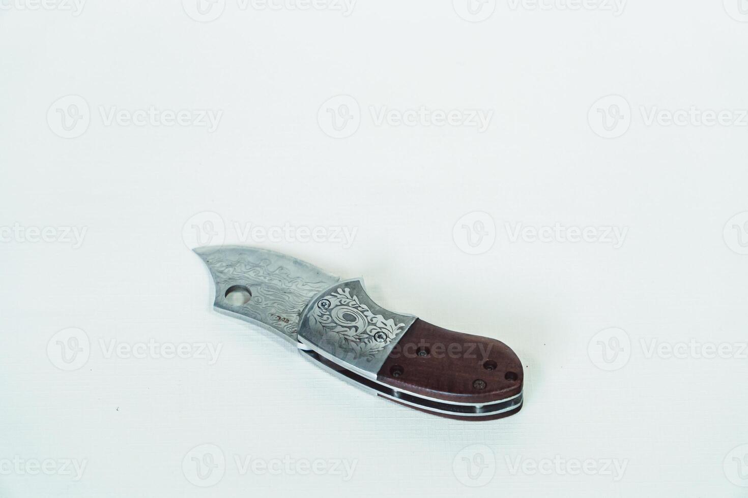 Close up of an adventure and bushcraft knife using a wooden handle. Knife with a sharp stainless steel blade with a wooden handle, perfect for outdoor adventures and bushcraft activities photo